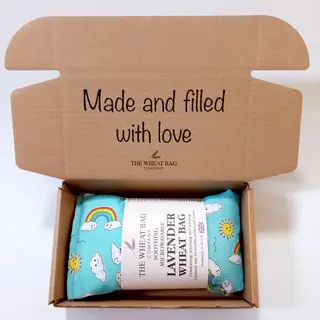 Open box with a lavender wheat bag inside. Text on lid: "Made and filled with love".