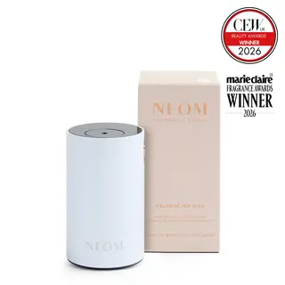 White NEOM Wellbeing Pod Mini next to beige box. CEW and Marie Claire awards logos displayed.