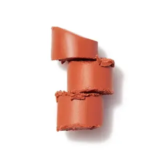 Three stacked slices of terracotta lipstick on a white background.