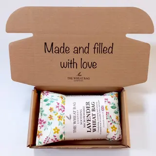 Open box with a floral lavender wheat bag and text "Made and filled with love".