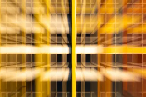 Abstract pattern with yellow and orange blurred lines and squares.