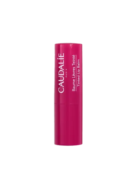 Pink Caudalie tinted lip balm tube with white text.