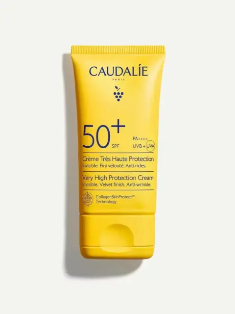 Yellow tube of Caudalie SPF 50+ sun cream with anti-wrinkle protection.