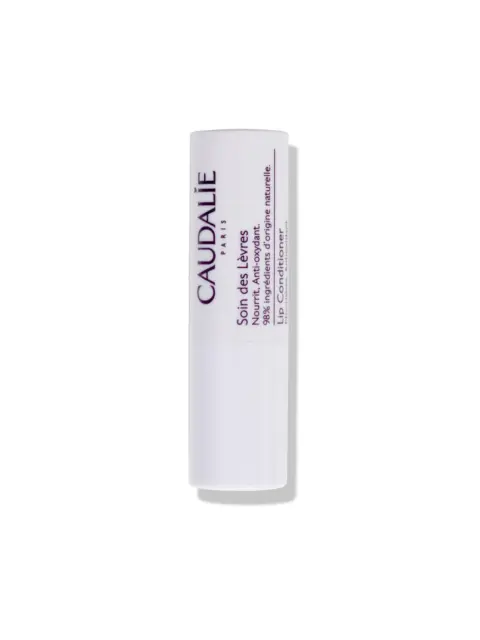 White tube of Caudalie lip conditioner with text on side.
