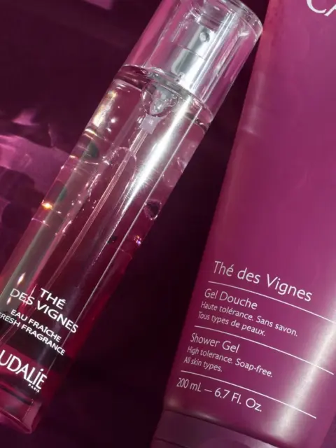 Caudalie Thé des Vignes fragrance and shower gel on a purple background.