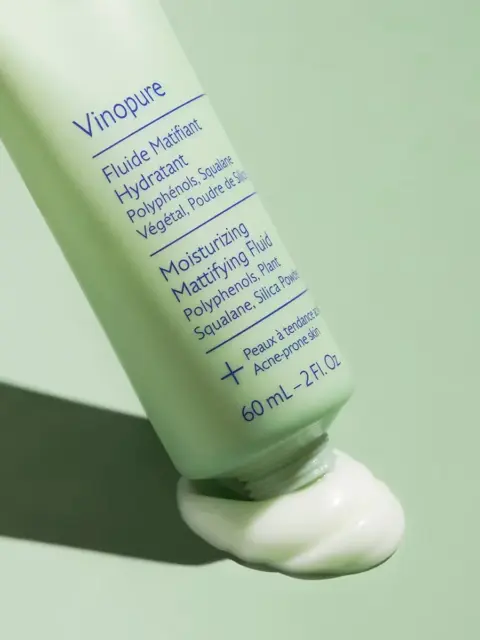 Vinopure Moisturising Mattifying Fluid, 60 mL, green tube on green background, cream oozing out.