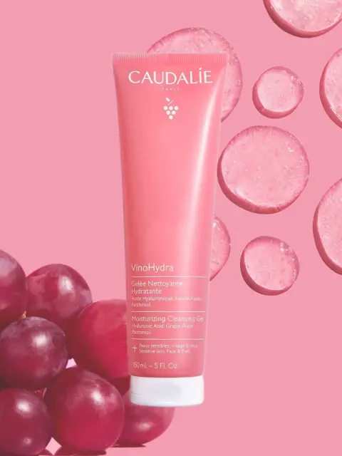 Caudalie VinoHydra Cleansing Gel tube with grapes and pink background.