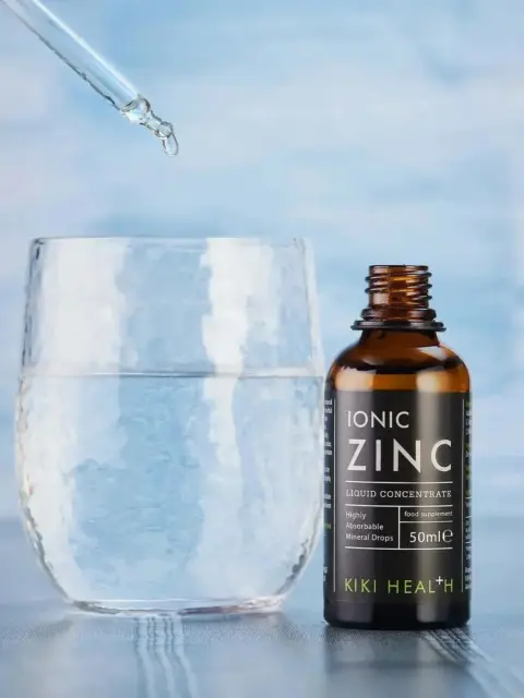 Dropper adding liquid to glass beside Ionic Zinc bottle.