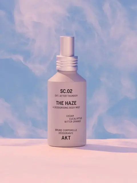Body mist bottle labelled "The Haze" with cedar, eucalyptus, and bitter orange.