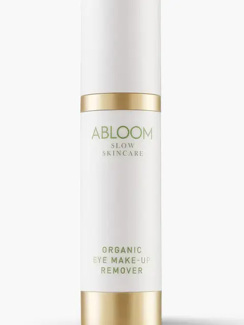 White bottle with gold accents labelled "Abloom Organic Eye Make-Up Remover".