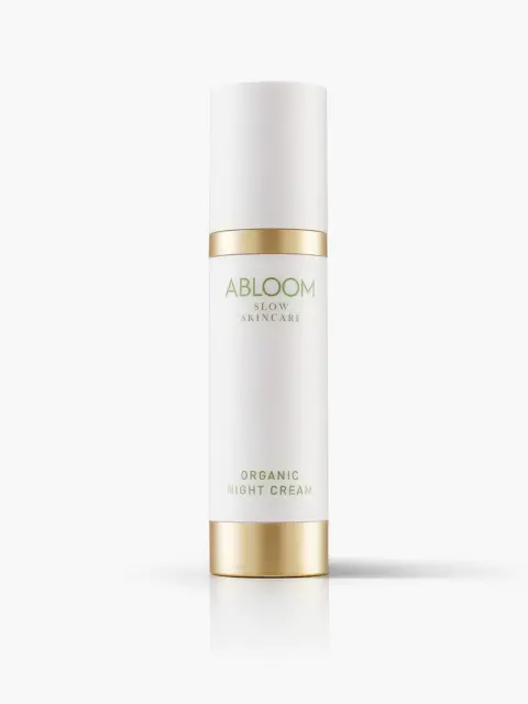 White bottle with gold accents labelled "Abloom Organic Night Cream".