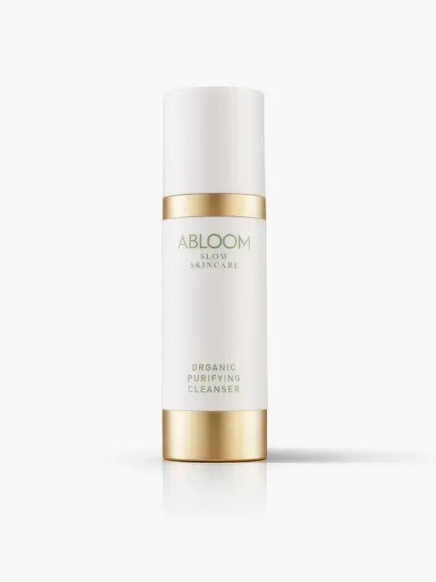 Abloom Slow Skincare Organic Purifying Cleanser in a white and gold bottle.