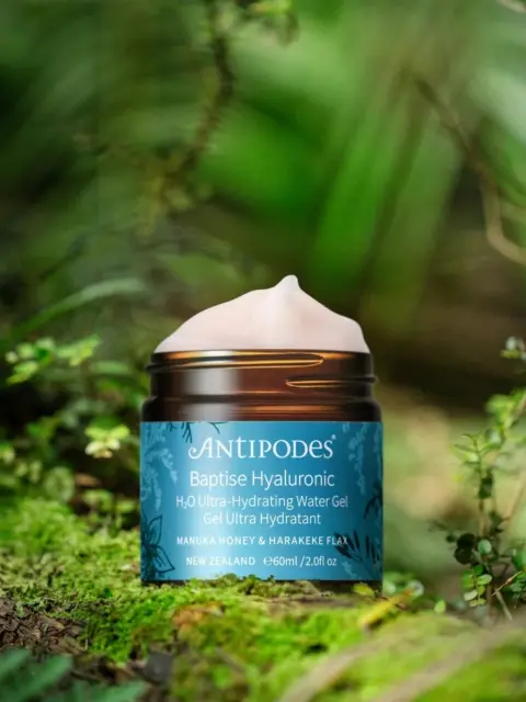 Antipodes Baptise Hyaluronic Gel, 60ml jar, on mossy forest floor.
