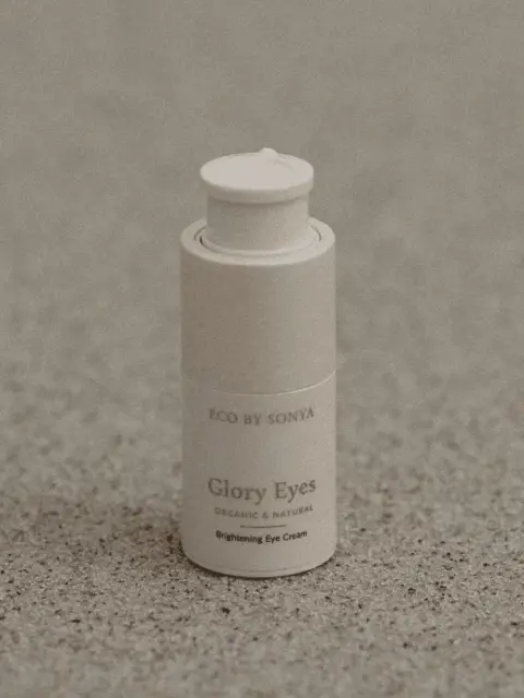 Eco by Sonya Glory Eyes Brightening Eye Cream on speckled surface.