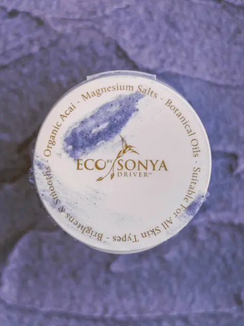Eco by Sonya jar lid with blue cream, text includes Organic Acai, Magnesium Salts.