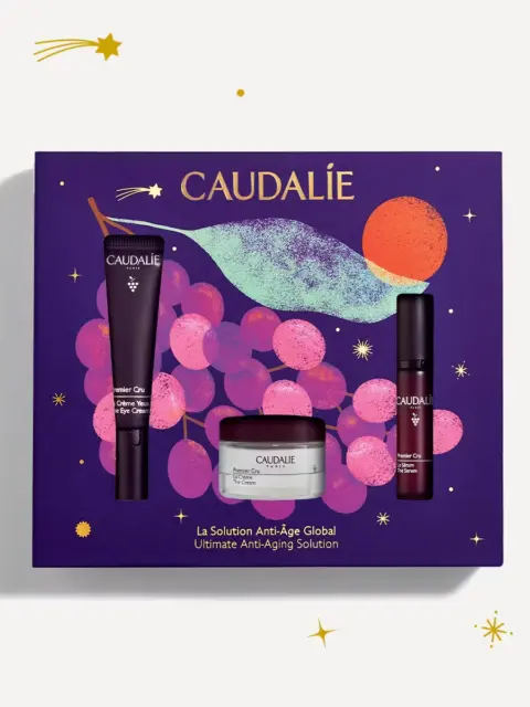 Caudalie skincare gift set with eye cream, serum, and cream on purple grape-themed box.