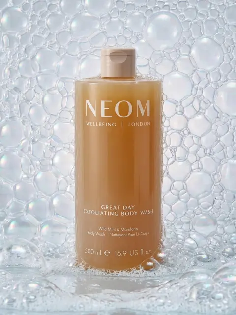 NEOM Great Day Exfoliating Body Wash, 500ml, surrounded by bubbles.