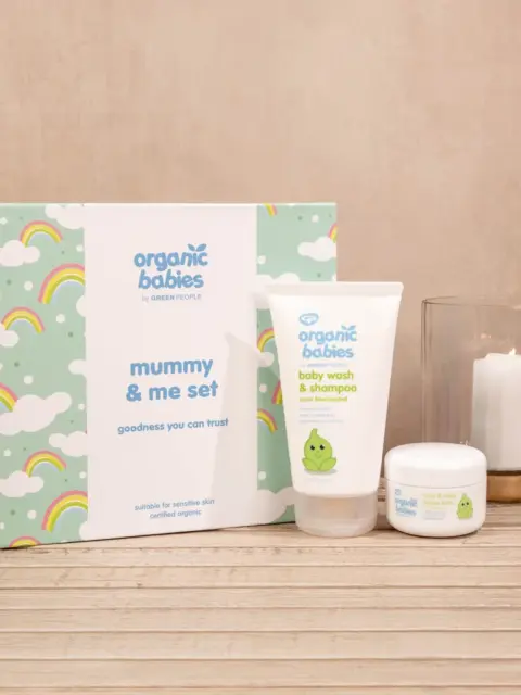 Organic Babies Mummy & Me set with baby wash, cream, and candle on wooden surface.