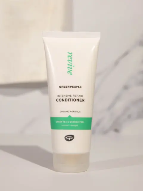 Green People Intensive Repair Conditioner tube on a light background.