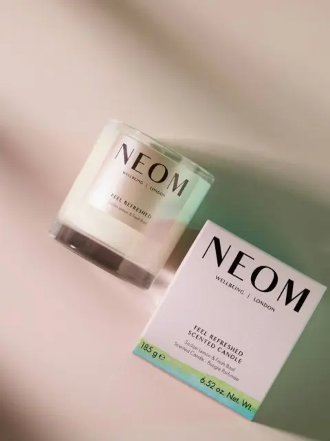 NEOM scented candle and box on a light surface.