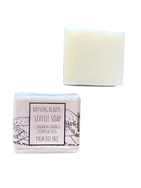 Two bars of Seville soap, one wrapped, one unwrapped. Label reads: "Palm oil free".