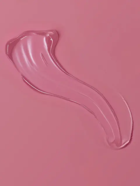 Clear gel smear on a pink background.