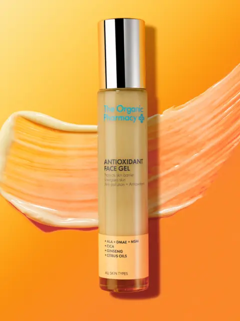 Antioxidant Face Gel by The Organic Pharmacy on orange background with gel smear.