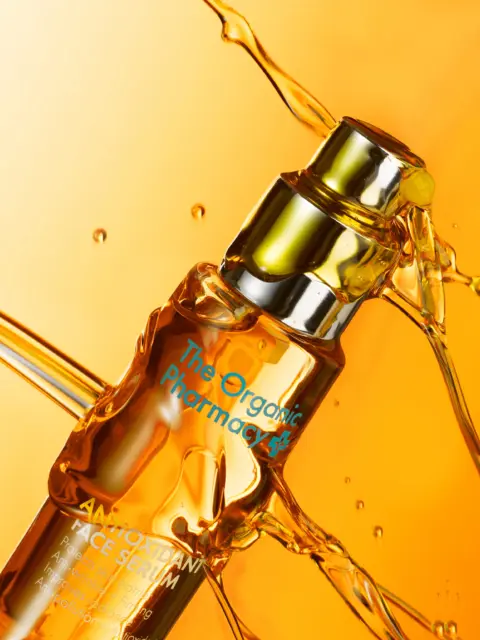 The Organic Pharmacy Antioxidant Face Serum with liquid splash.