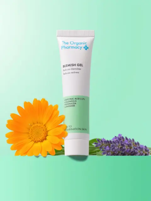 Blemish gel tube with calendula and lavender flowers on green background.