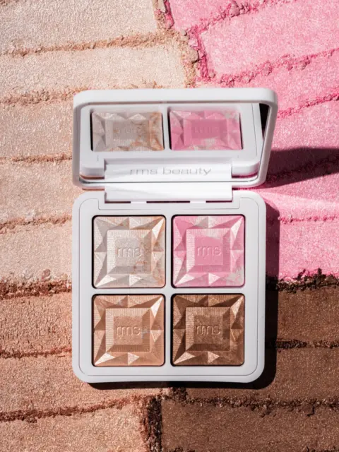 Makeup palette with four shades on textured background. "rms beauty" text on the case.