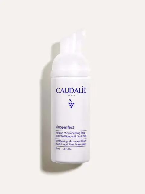 Caudalie Vinoperfect Brightening Micropeel Foam, 50ml bottle on a light background.