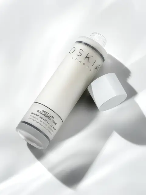 Oskia Rest Day Cleansing Milk bottle on white surface, cap off.