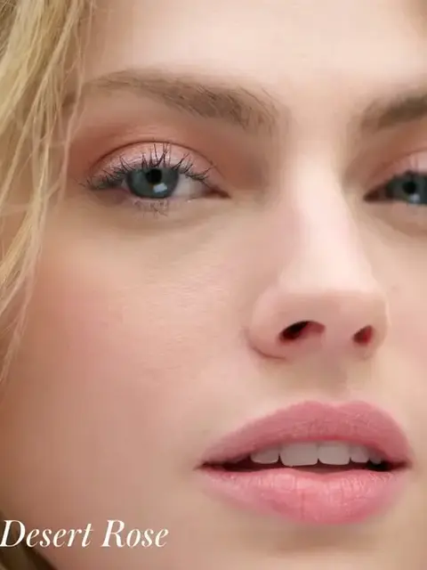 Close-up of a woman's face with pink eyeshadow and lipstick. Text: "Desert Rose".