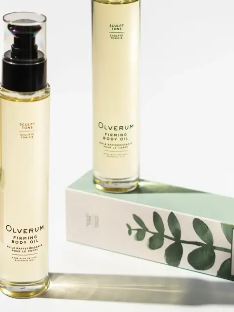 Olverum Firming Body Oil bottles with packaging featuring green leaf design.