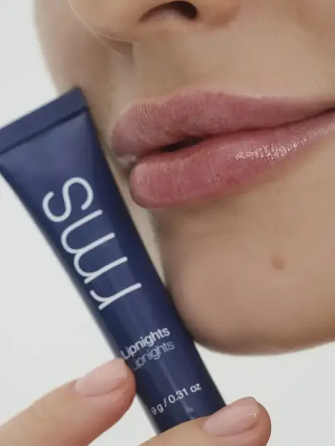Close-up of lips with a blue tube labelled "rms Liplights".