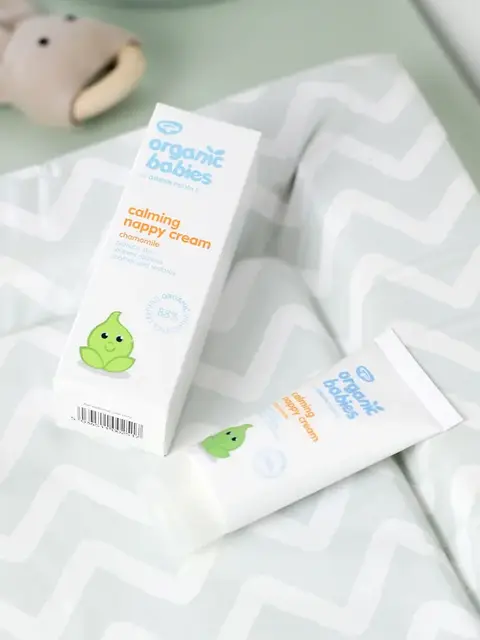 Organic Babies calming nappy cream on a patterned changing mat.