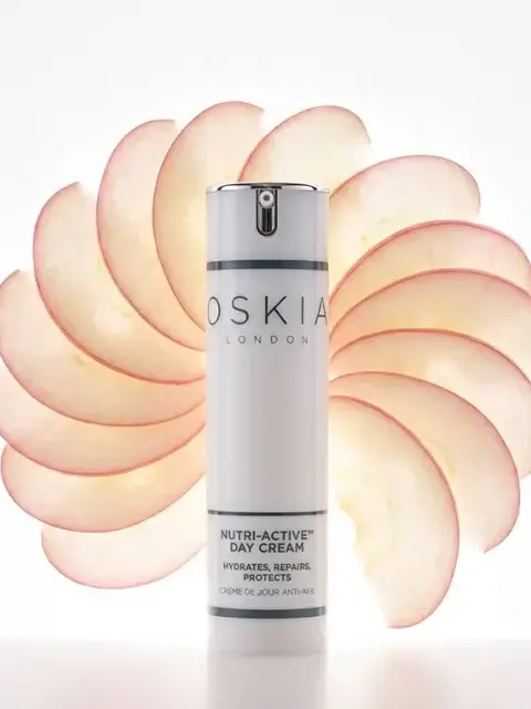 Oskia London Nutri-Active Day Cream with apple slices in the background.