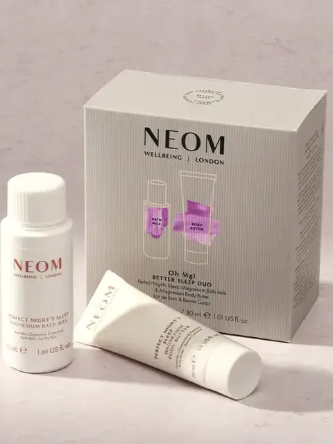 NEOM Better Sleep Duo set with bath milk and body butter on a light surface.
