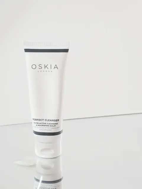 Oskia London Perfect Cleanser tube on reflective surface.