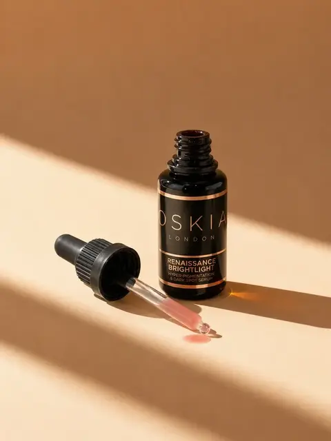 Oskia London Renaissance Brightlight serum with dropper on beige background.