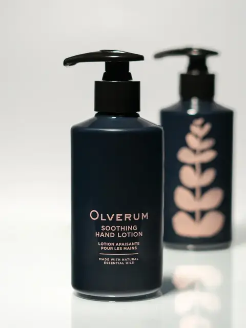 Two bottles of Olverum Soothing Hand Lotion with pump dispensers.
