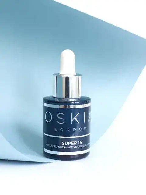 Oskia London Super 16 serum bottle with dropper on light blue background.
