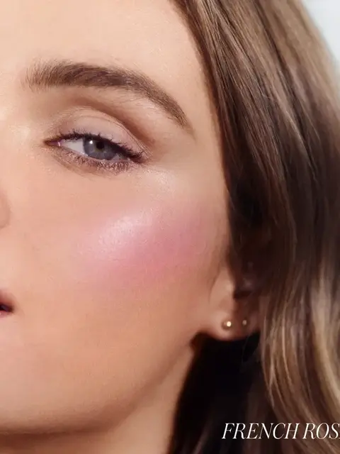 Close-up of a woman's face with pink blush. Text: "French Rosé".