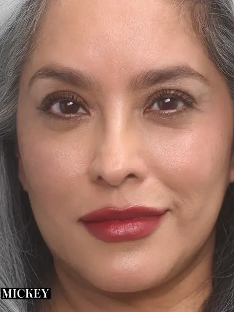 Woman with grey hair and red lipstick, text "Mickey" in corner.