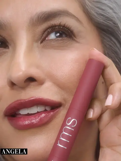 Woman holding a pink rms beauty product near her face. Text: "ANGELA".