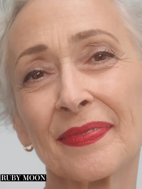 Older woman with short grey hair and red lipstick. Text: "RUBY MOON".