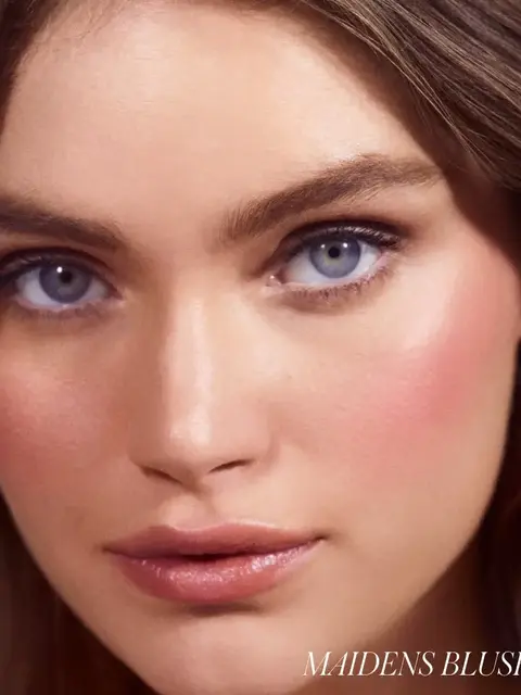 Close-up of a woman's face with pink blush. Text: "MAIDENS BLUSH" in the corner.