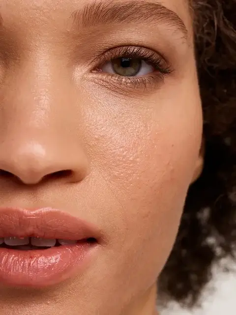 Close-up of a person's face showing smooth skin and natural lip colour.