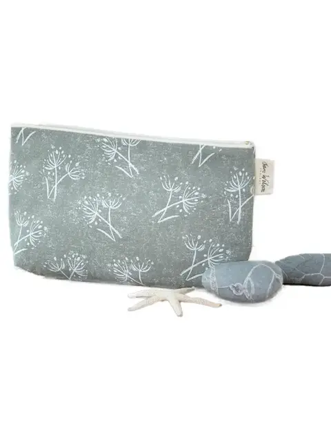 Grey pouch with white floral pattern, two grey stones, and a small starfish.