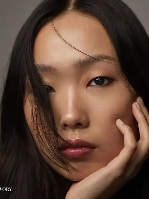 Person with long dark hair, hand on face, text "IVORY" in corner.